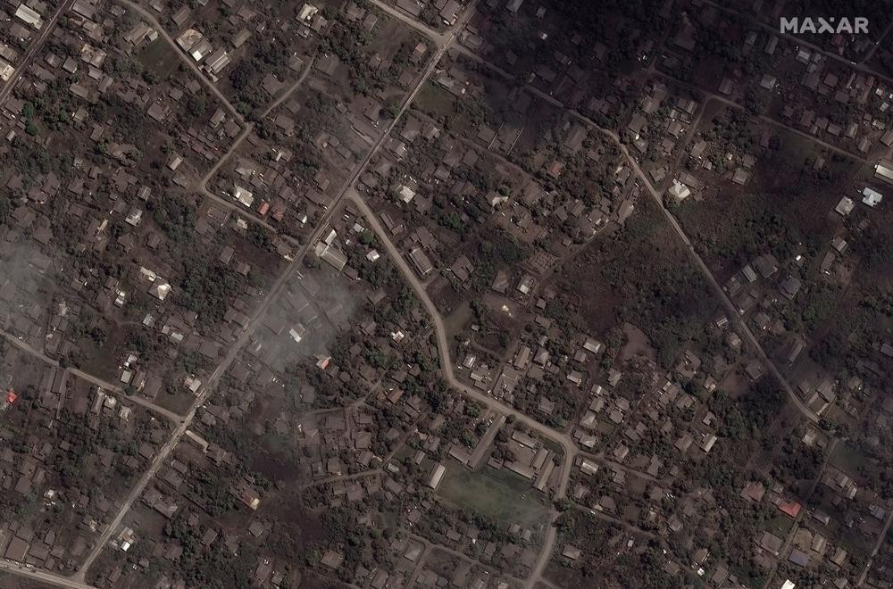 This satellite image provided by Maxar Technologies shows ash covered homes and buildings in Tonga Tuesday, Jan. 18, 2022 after a huge undersea volcanic eruption.