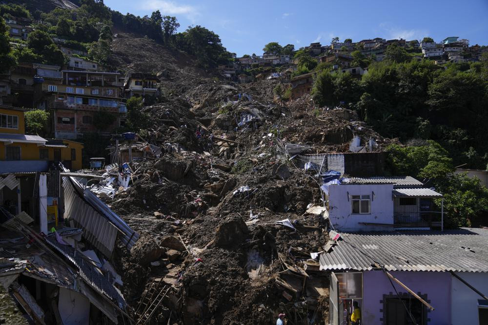 The path of a mudslide marks a hillside filled with homes in Petropolis, Brazil, Thursday, Feb. 17, 2022.