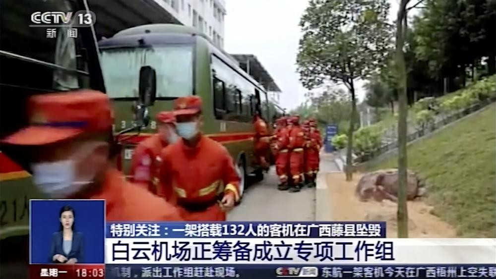 In this image taken from video footage run by China's CCTV, emergency personnel prepare to travel to the site of a plane crash near Wuzhou in southwestern China's Guangxi Zhuang Autonomous Re