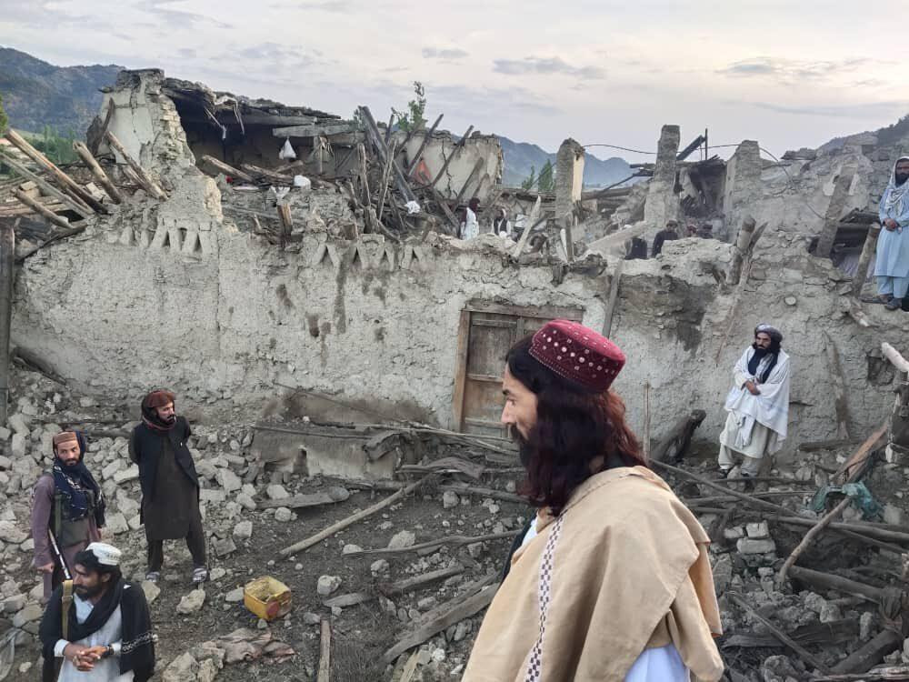 In this photo released by a state-run news agency Bakhtar, Afghans look at destruction caused by an earthquake in the province of Paktika, eastern Afghanistan, Wednesday, June 22, 2022. (Bakh