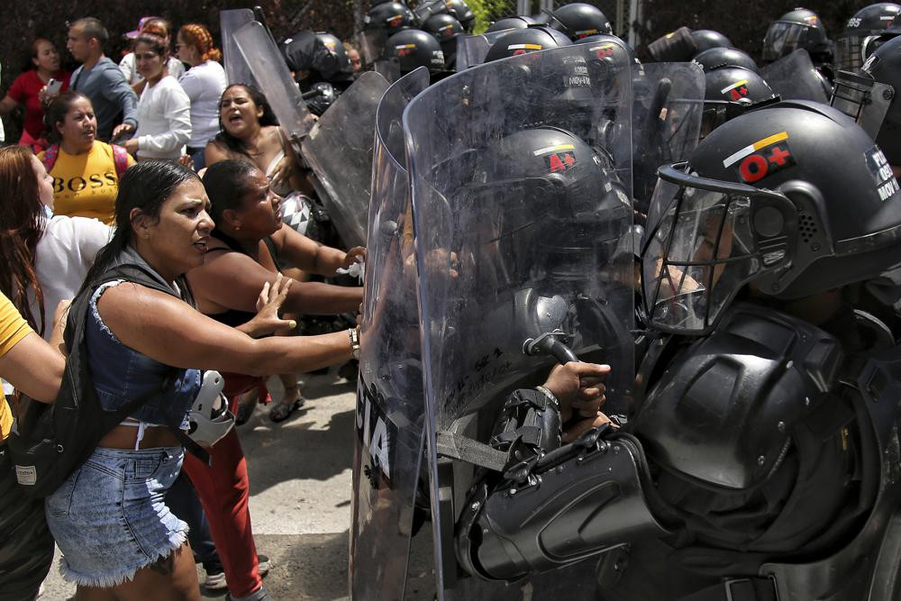 Inmates' relatives push police's shields outside a prison where there was a deadly fire in Tulua, Colombia, Tuesday, June 28, 2022.  AP/RSS Photo
