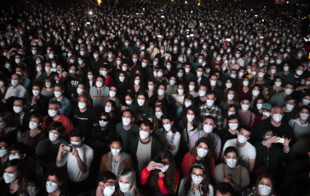 People using face masks attend a music concert in Barcelona, Spain, March 27, 2021.
