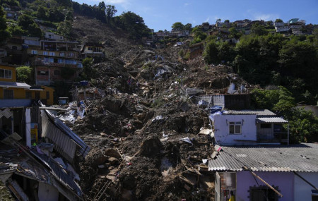 The path of a mudslide marks a hillside filled with homes in Petropolis, Brazil, Thursday, Feb. 17, 2022.