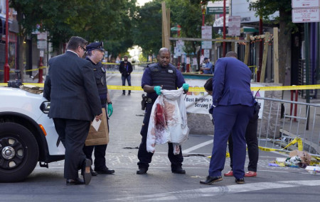 Philadelphia Police investigators work the scene of a fatal overnight shooting on South Street in Philadelphia, Sunday, June 5, 2022.