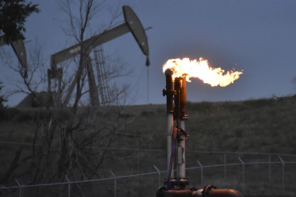 FILE - A flare burns at a well pad Aug. 26, 2021, near Watford City, N.D. The levels of the crucial heat-trapping gases in the atmosphere reached historic highs in 2023, growing at near-record fast paces, according to the U.S. National Oceanic and Atmospheric Administration.  AP/RSS Photo