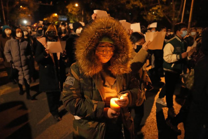 Protesters hold up blank papers and chant slogans as they march in protest in Beijing, Sunday, Nov. 27, 2022. AP/RSS Photo