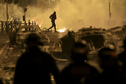 A demonstrator runs on the third night of protests sparked by the fatal police shooting of a 17-year-old driver in the Paris suburb of Nanterre, France, Friday, June 30, 2023. The June 27 shooting of the teen, identified as Nahel, triggered urban violence and stirred up tensions between police and young people in housing projects and other neighborhoods.  AP/RSS Photo