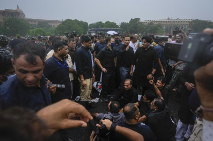 Congress party leader Rahul Gandhi, center in blue mask, and other lawmakers participate in a protest in New Delhi, India, Friday, Aug. 5, 2022. AP/RSS Photo