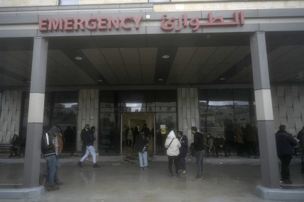 Journalists gather outside the Ibn Sina Hospital after the attack. AP/RSS Photo