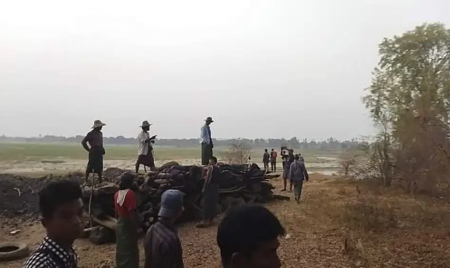 Men stand over a funeral pyre in Tar Taing village, as they prepare to cremate bodies of those found dead in the nearby village of Nyaung Yin, Myinmu township and in Tar Taing village, Sagaing township, central Myanmar on Thursday, March 2, 2023. AP/RSS Photo