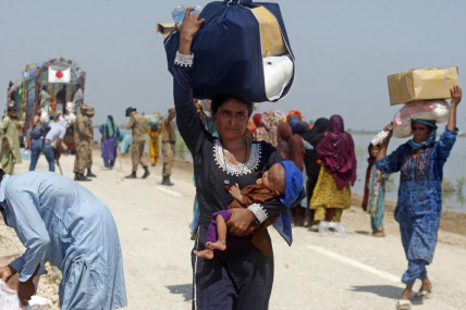 Victims of regional flooding from monsoon rains receive relief aid from the Pakistani Army in the Qambar Shahdadkot district of Sindh Province, Pakistan, Sept. 9, 2022. AP/RSS Photo