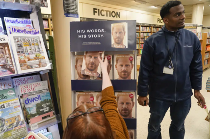 Copies of the new book by Prince Harry called "Spare" are placed on a shelf by a member of staff of a book store during a midnight opening in London, Tuesday, Jan. 10, 2023. AP/RSS Photo