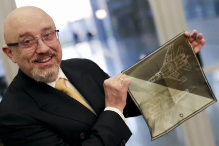Ukraine's Defense Minister Oleksiy Reznikov shows a handkerchief with a F-35 fighter jet when heading to a meeting with United States Secretary of Defense Lloyd Austin, on the sidelines of a NATO headquarters in Brussels, Tuesday, Feb. 14, 2023.  AP/RSS Photo