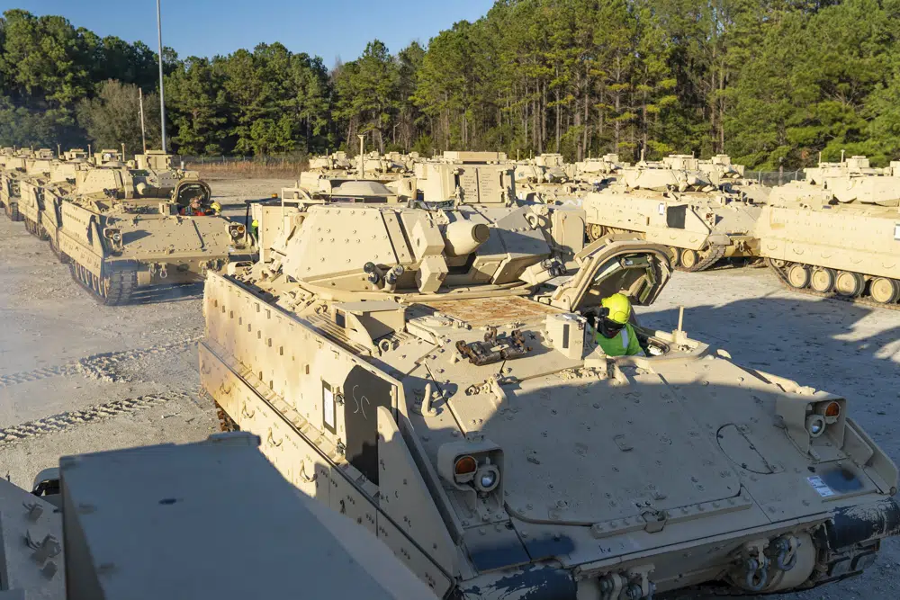 In this image provided by U.S. Transportation Command, a stevedore sits in a Bradley Fighting Vehicle before loading it onto the ARC Wallenius Wilhemsen Jan. 25, 2023, at the Transportation Core Dock in North Charleston, South Carolina. AP/RSS Photo