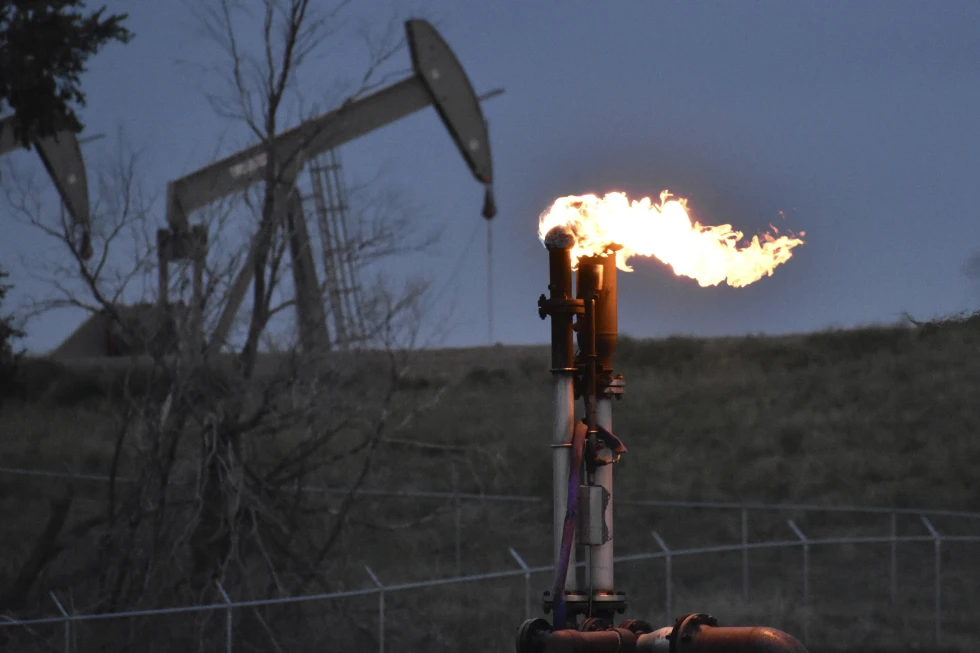FILE - A flare burns at a well pad Aug. 26, 2021, near Watford City, N.D. The levels of the crucial heat-trapping gases in the atmosphere reached historic highs in 2023, growing at near-record fast paces, according to the U.S. National Oceanic and Atmospheric Administration.  AP/RSS Photo