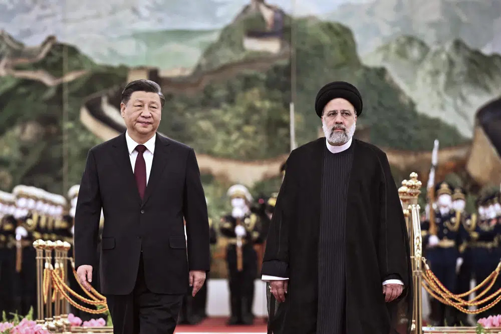 FILE - In this photo released by Xinhua News Agency, visiting Iranian President Ebrahim Raisi, right, walks with Chinese President Xi Jinping after reviewing an honor guard during a welcome ceremony at the Great Hall of the People in Beijing, Tuesday, Feb 14, 2023. (AP/RSS Photo)