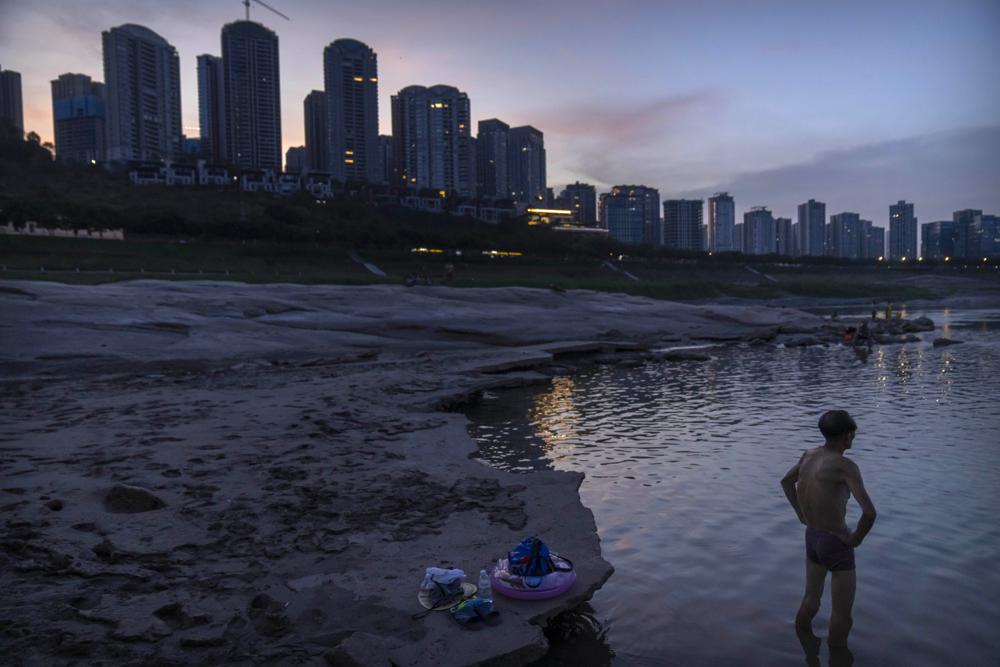 A man stands in shallow water near the dry riverbed of the Yangtze River in southwestern China's Chongqing Municipality, Friday, Aug. 19, 2022. AP/RSS Photo