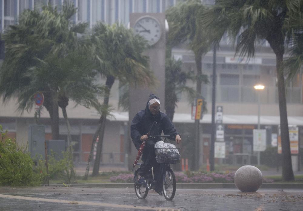 A man on a bicycle makes his way through the rain in Miyazaki, southern Japan, Sunday, Sept 18, 2022, as a powerful typhoon approaching southern Japan on Sunday lashed the region with strong winds and heavy rain. (AP/RSS Photo)