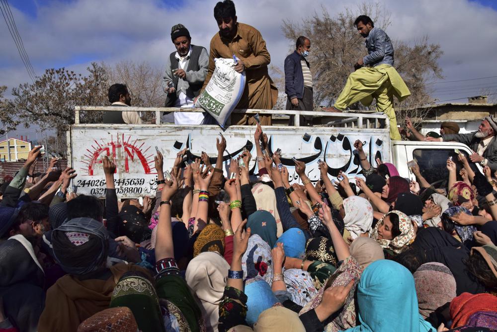 FILE - People jostle each other to buy subsidized sacks of wheat flour in Quetta, Pakistan, Thursday, Jan. 12, 2023, after a recent price hike of flour in the country. AP/RSS Photo
