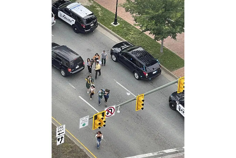 People scatter from a shooting scene as police arrive Tuesday, June 6, 2023, in Richmond, Virginia. (AP/RSS Photo)