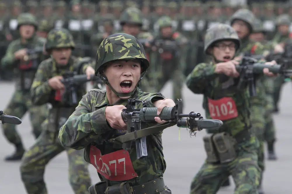 FILE - New recruits practice thrusting with their bayonets at a military training center in Hsinchu County, northern Taiwan on April 22, 2013. AP/RSSPhoto
