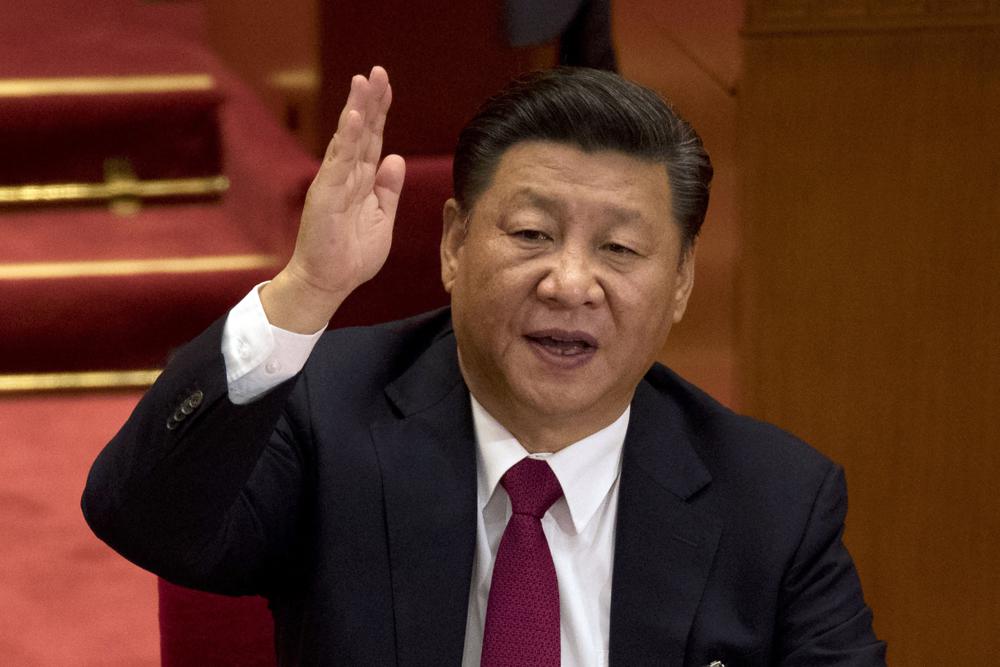 FILE - Chinese President Xi Jinping raises his hand to show approval of a work report during the closing ceremony for the 19th Party Congress at the Great Hall of the People in Beijing on Oct. 24, 2017. AP/RSS Photo