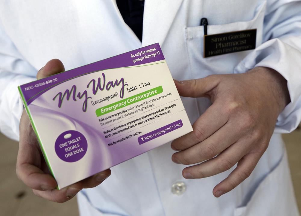 FILE - Pharmacist Simon Gorelikov holds a generic emergency contraceptive at the Health First Pharmacy in Boston on May 2, 2013.  AP/RSS Photo
